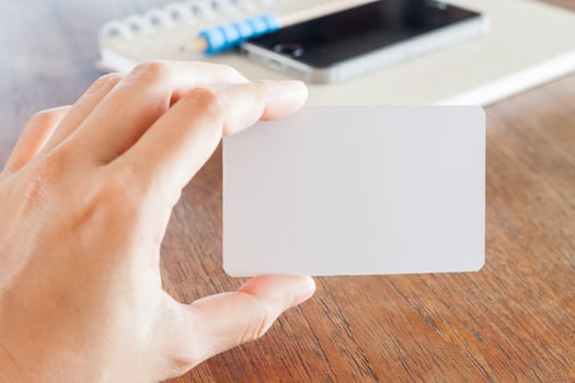 Hand holding a business card mock-up photo