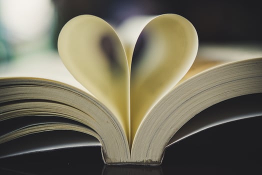 Curled paper in the shape of a heart with blurred bokeh photo
