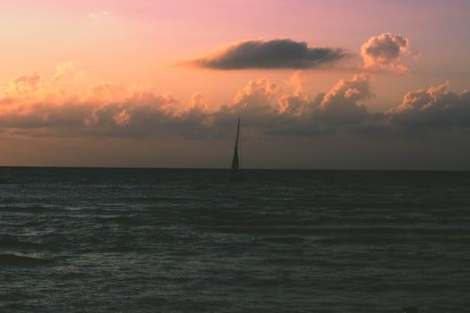 Dark ocean under an orange sky photo