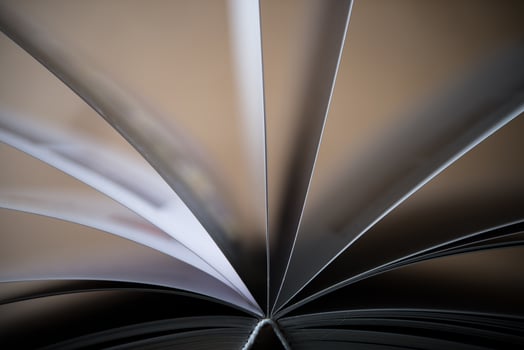 Close-up of an opened book on a wooden table photo