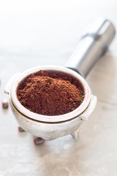 Coffee grinder on a white table photo