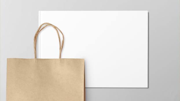 Blank brown paper carrier bag with handles for shopping photo