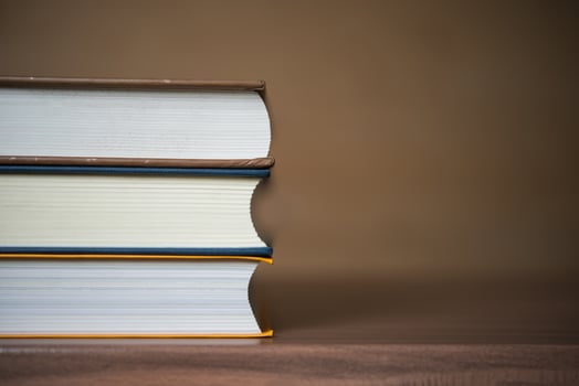 Stack of books on wooden table photo