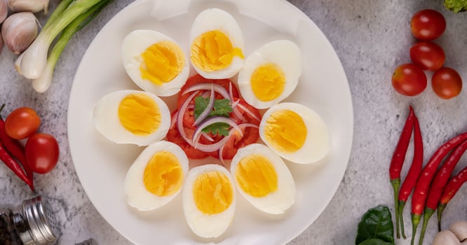 Half boiled eggs with tomatoes and spring onions photo