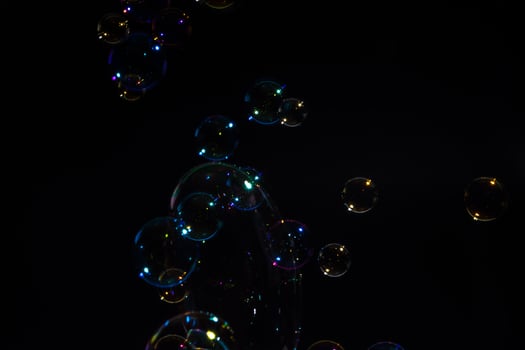 Soap bubbles on black background photo