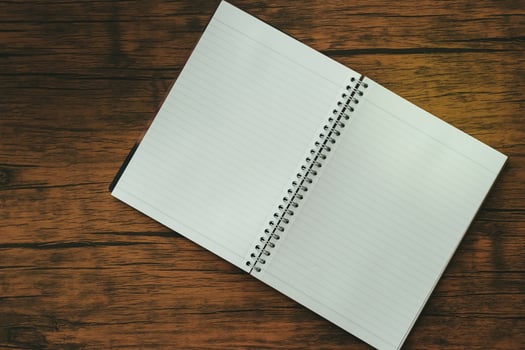 Notebook on brown wooden table photo