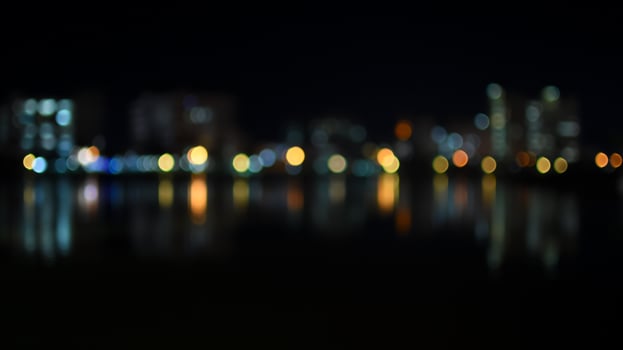 Colorful bokeh of city skyline from the river in night time photo
