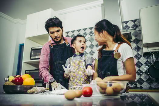 Happy family enjoying their time cooking together in the kitchen photo