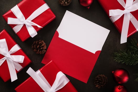 Blank white greeting card and envelope mockup with Christmas gifts decorations on grunge background photo