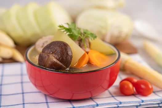 Pork meatball soup surrounded by ingredients photo