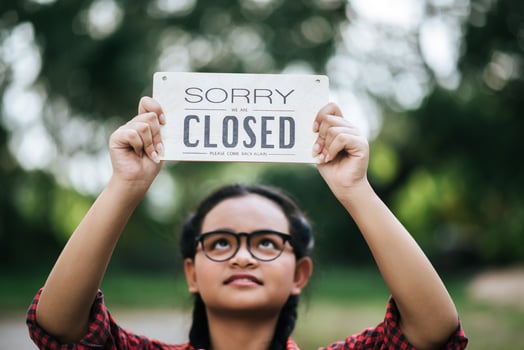 Girl holding a closed sign photo