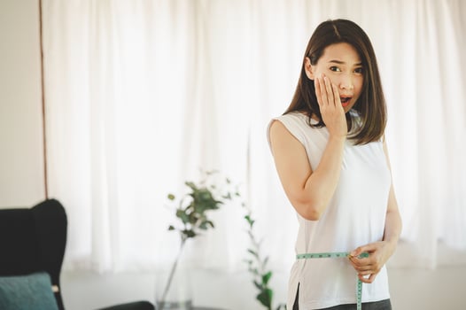 Woman using measuring tape photo