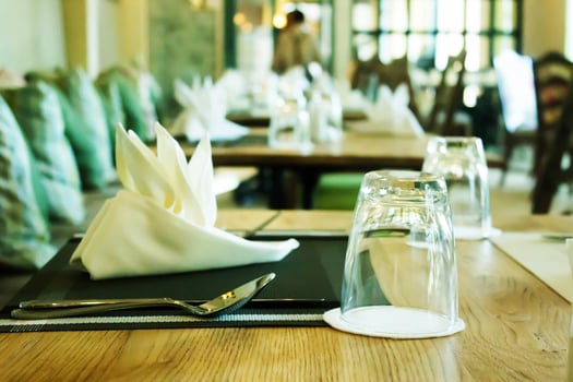 Glasses and silverware on table in restaurant photo