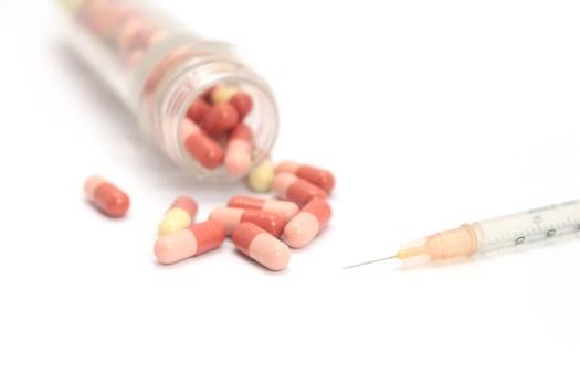 Pills and a syringe photo