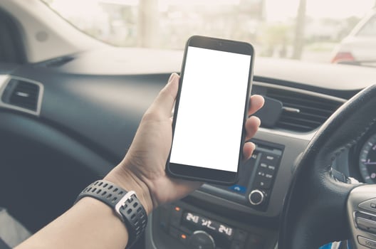 Hand holding a mobile phone with a blank screen photo