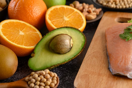 Legumes, fruit and salmon fish on a wooden chopping board photo