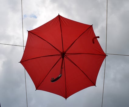 Red umbrella in sky photo