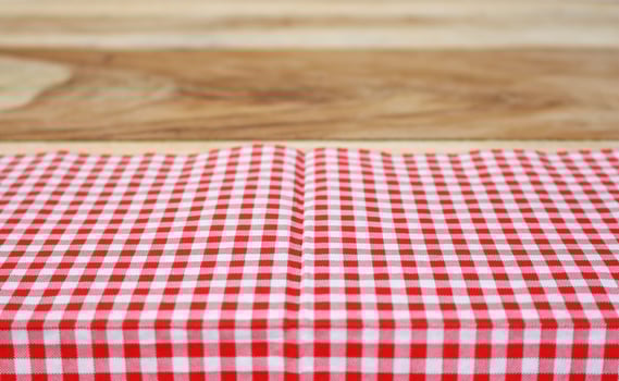 Red cloth on wooden table photo