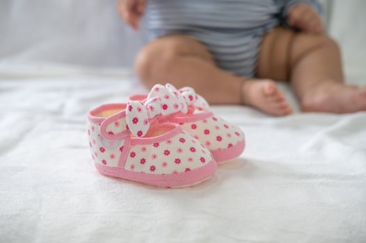Newborn shoes on a white mattress photo