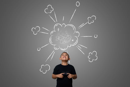 Young boy plays fun strategy games drawn on chalkboard, concept photo