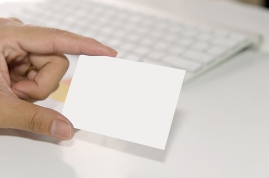 Hand holding white business card photo