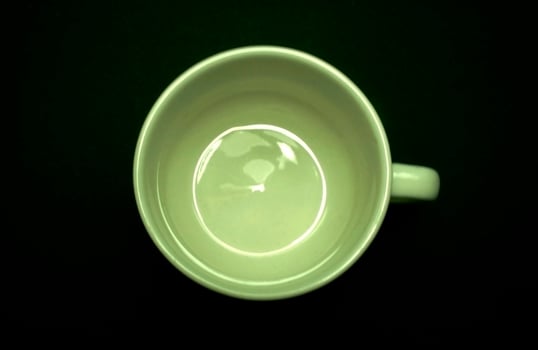 Green mug on black photo