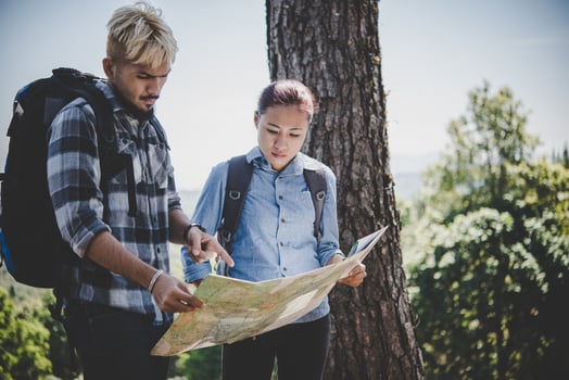 Young adventure couple hiking to a mountain photo