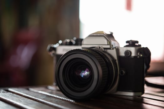 Vintage film camera on wooden table photo