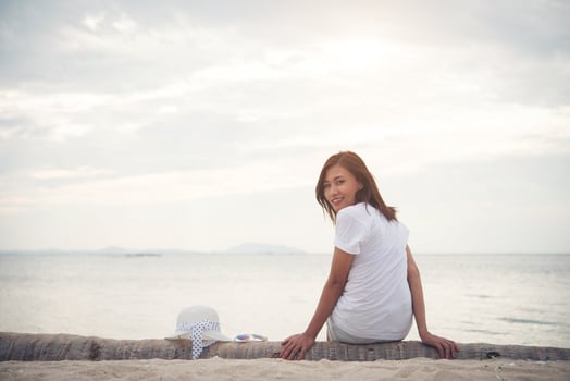 Young beautiful woman relaxing at the beach photo