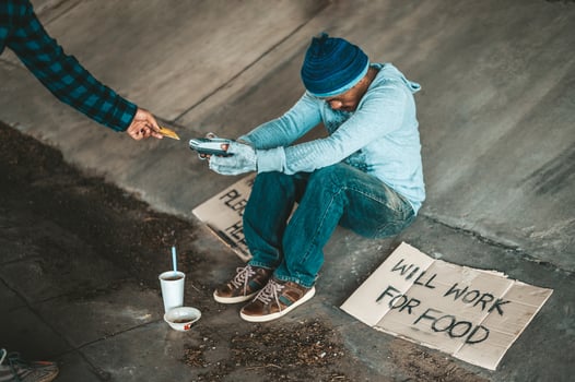 Beggars sitting under the bridge with a credit card swipe machine photo