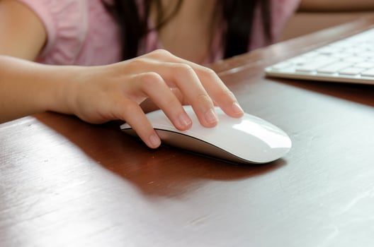 Children's hand on a computer mouse photo