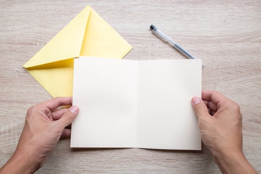 Man holding a blank white card photo