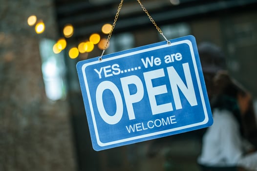 Open sign through the glass window at coffee shop photo