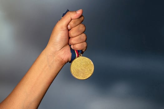 Person holding a gold medal photo