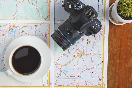 Camera and coffee on a map photo
