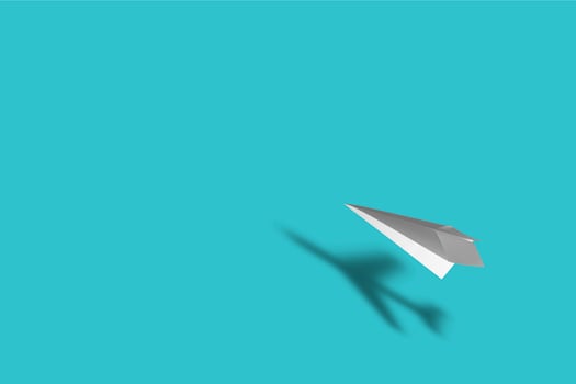 Paper plane with the shadow of a real plane on blue background photo