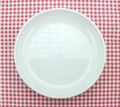 Plate on checkered tablecloth photo