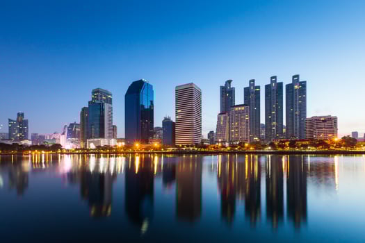 Cityscape reflection in water at night photo