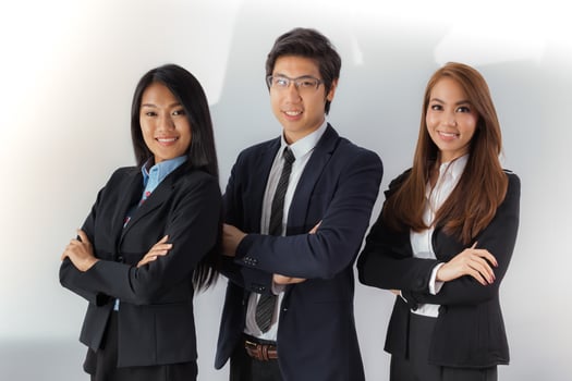 Three young professionals posing together photo