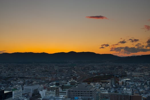 Sunrise over a city with mountains photo