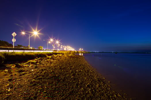 Road near water at night photo