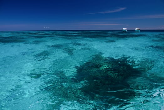 Clear water and sky with boats photo