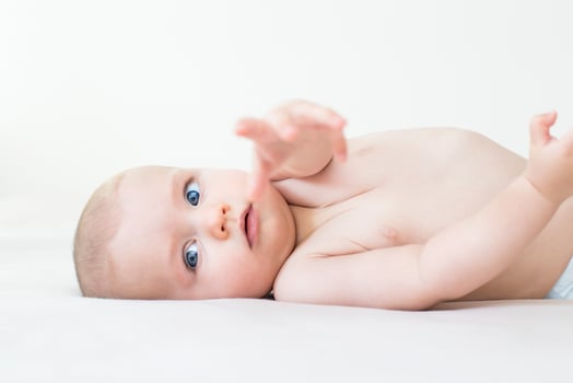 Cute baby girl lying on bed photo