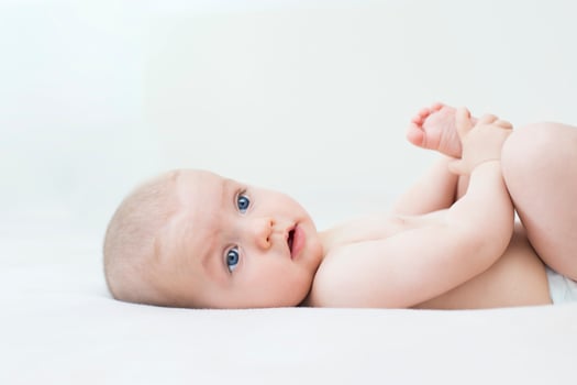 Cute baby girl lying on bed photo