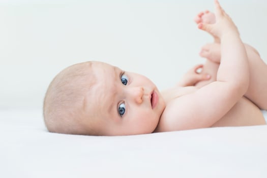 Cute baby girl lying on bed photo