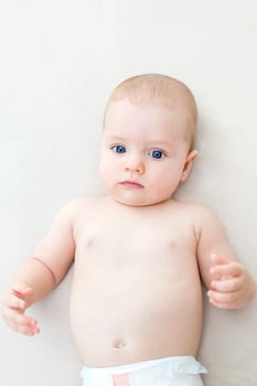 Cute baby girl lying on bed photo