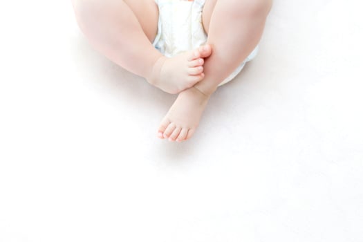 Cute baby girl lying on bed photo