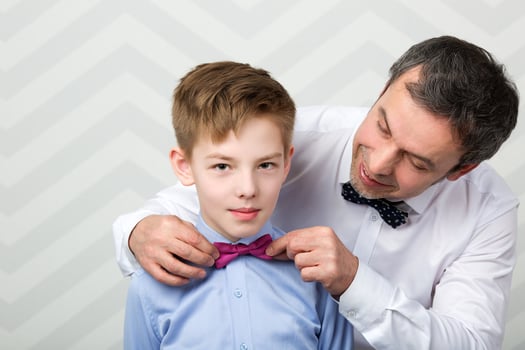 Father adjusting son's bowtie photo