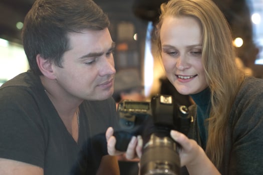 Young people looking through the photos on a camera