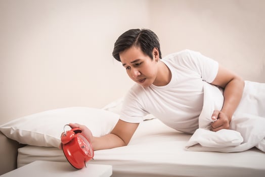 Man turns off alarm clock in a hurry photo